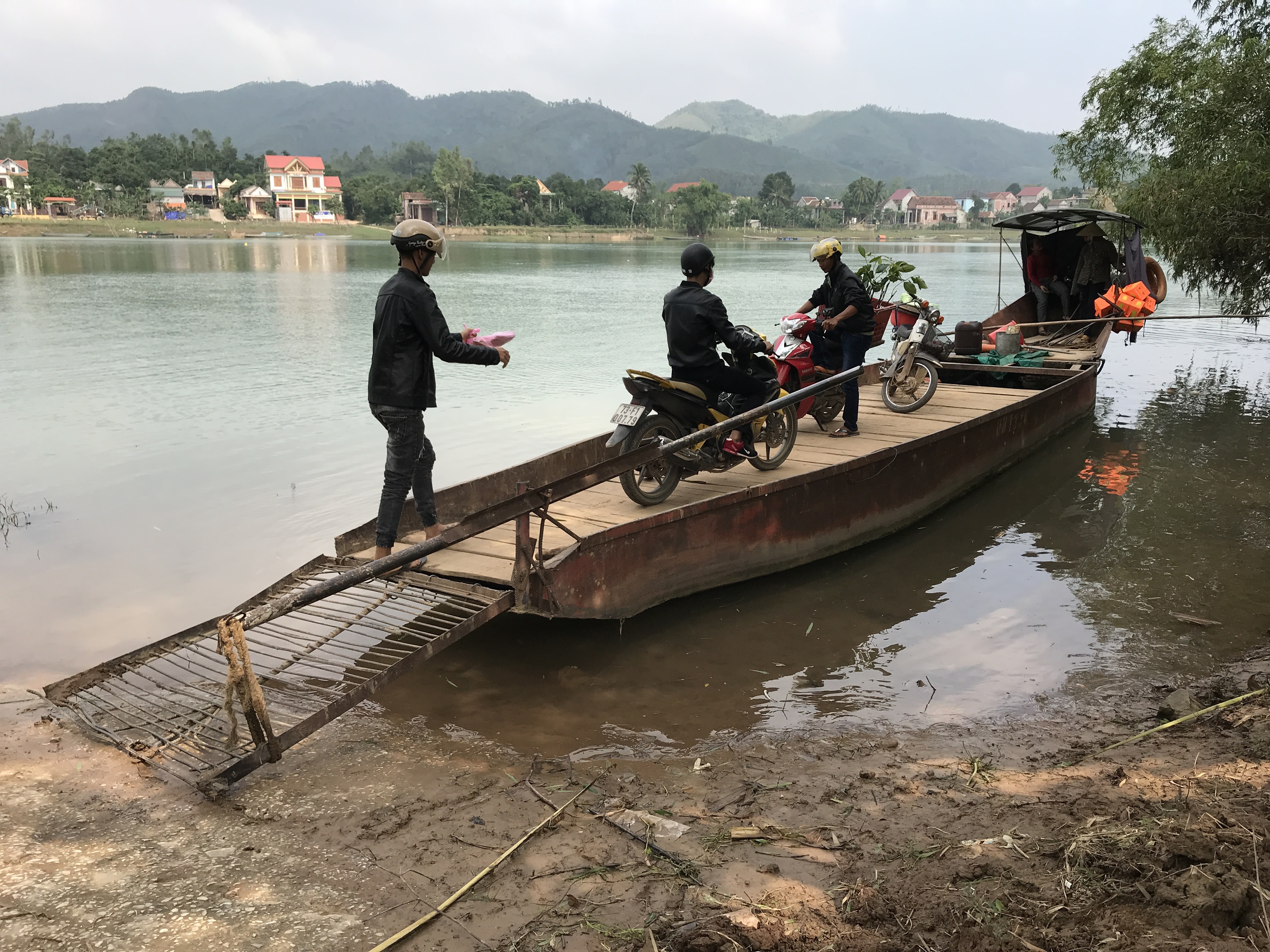 Motorbike boat taxi across a river in Vietnam.