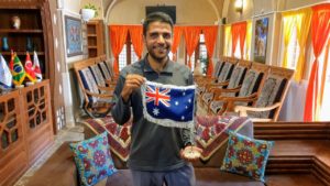 Soroush holding the Australian flag. His visa to live and work in Australian was approved while we were on our epic Iran road trip | VincePerfetto.com